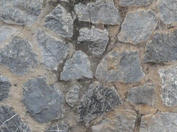 Grey stone set randomly in wall.